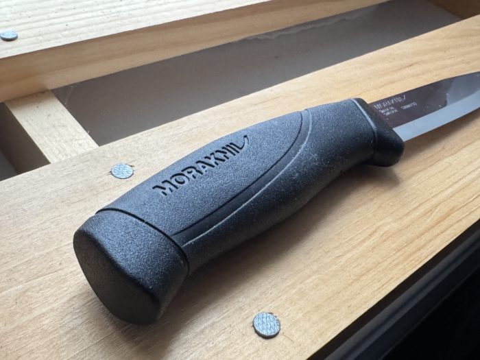 The Morakniv Companion on a piece of wood.