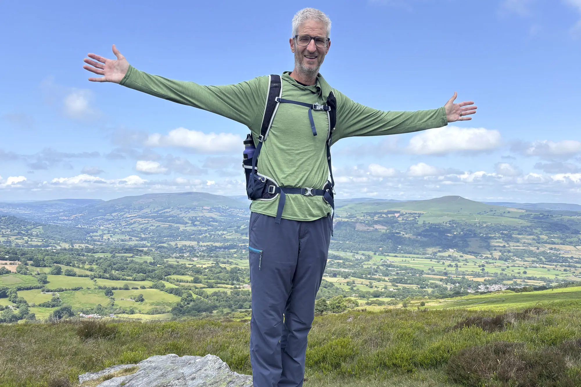 a man wearing Patagonia Capilene Cool Daily Hoody while hiking