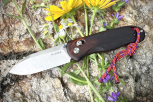 kizer Drop Bear knife among flowers