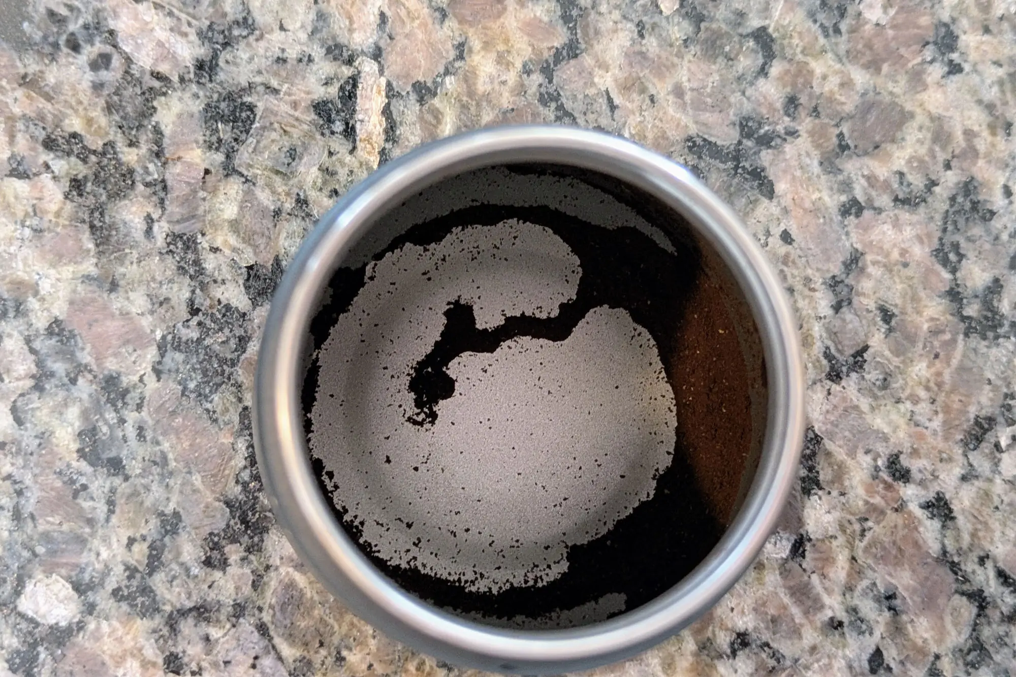 Top-down view of ground coffee inside a MiiR coffee grinder