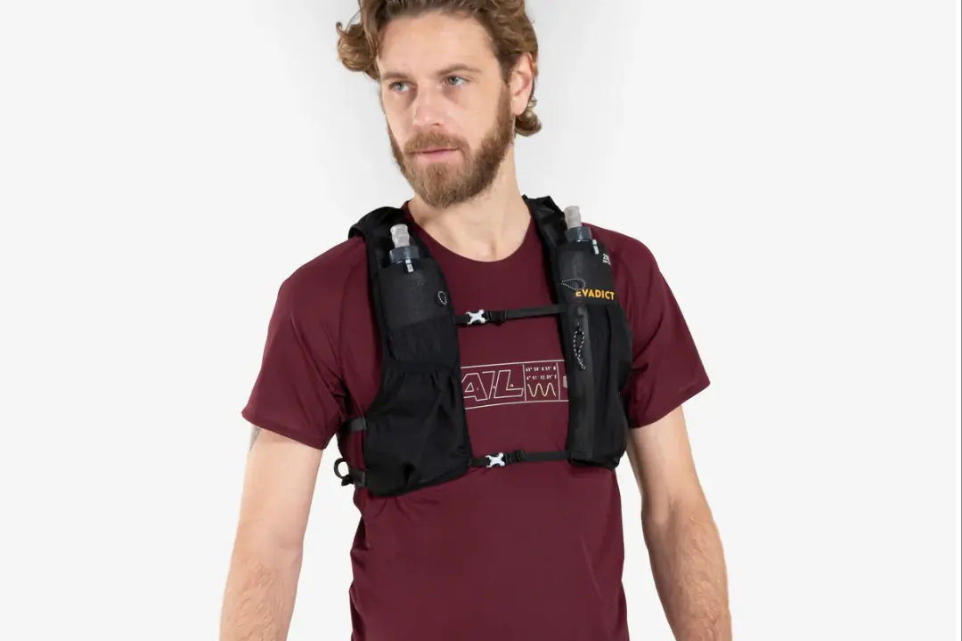 Man in red shirt wears black running vest