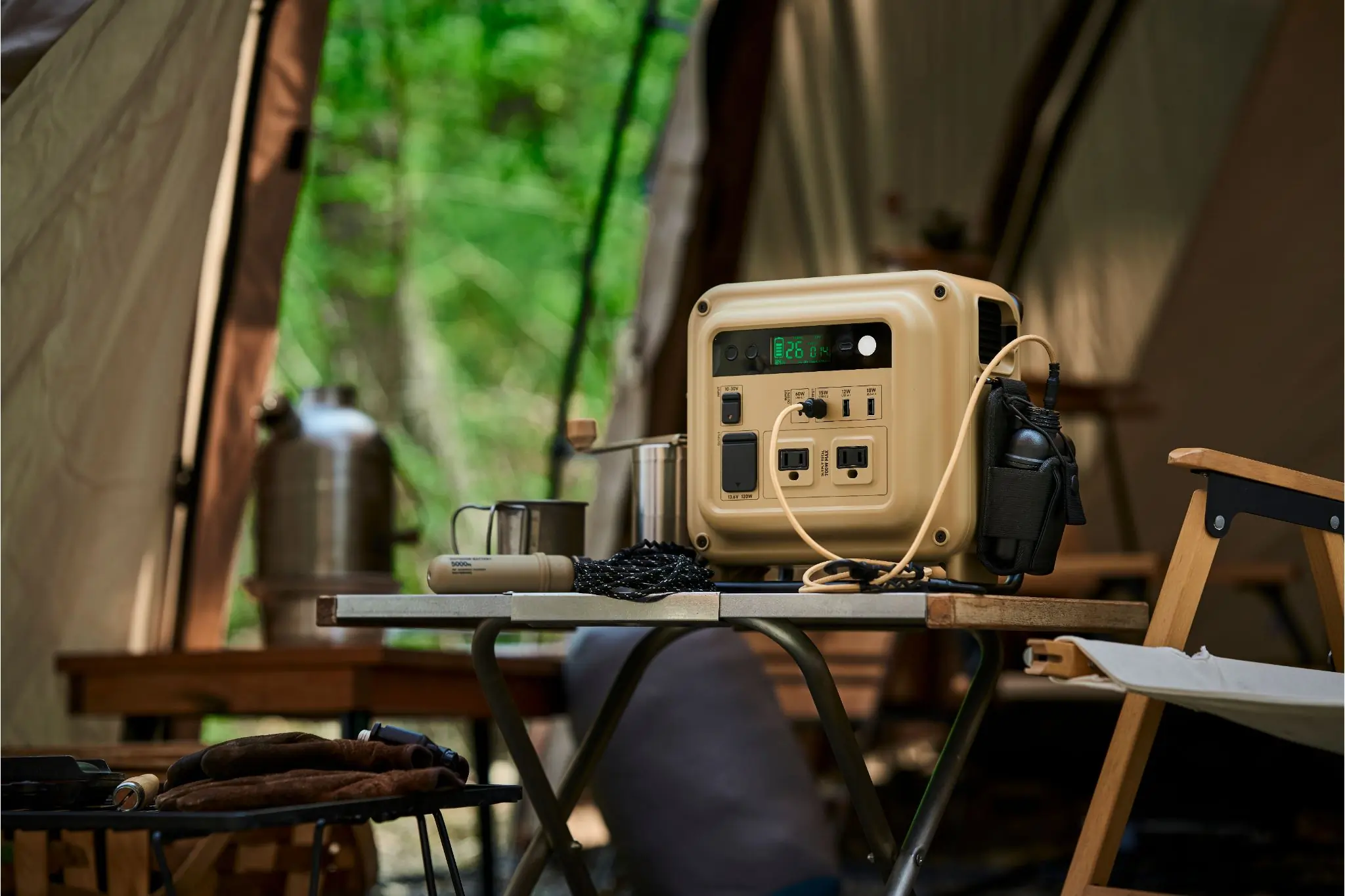Tan Power Bank sits set up on a table inside a tent 