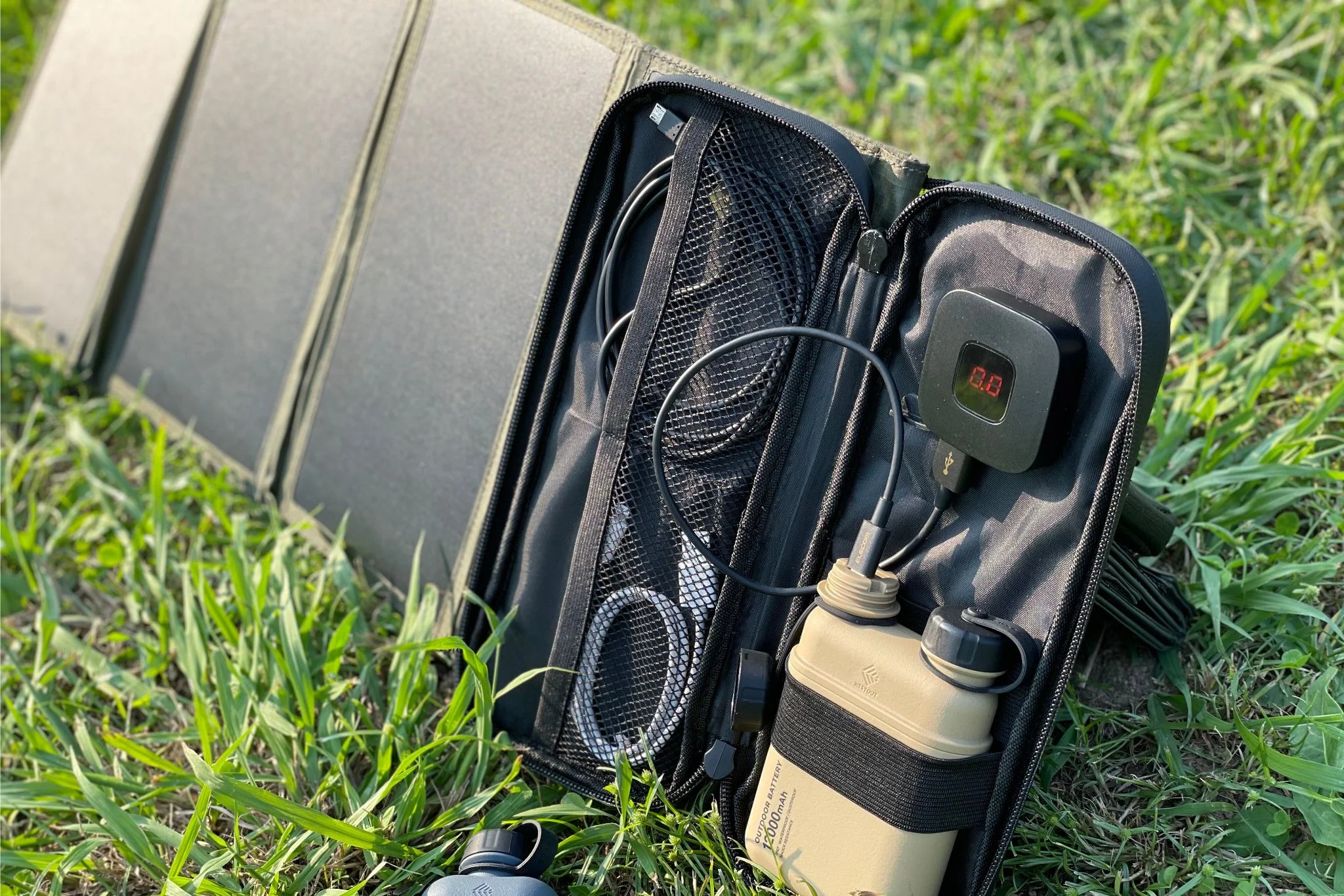 Nestout solar charger in use outside with power bank