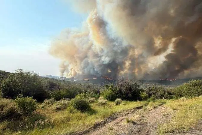 Heavy smoke fills air with mountain background