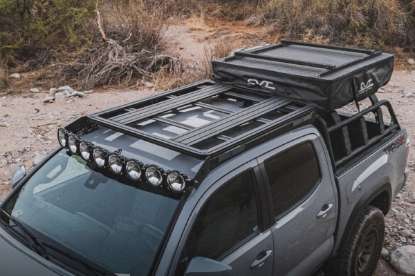 Gray Toyota Tacoma with roof rack and lights 