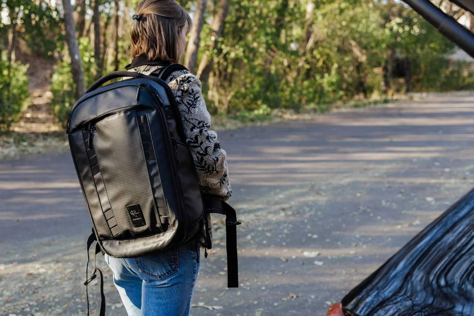 a woman with The Nomatic McKinnon 35L Camera Backpack