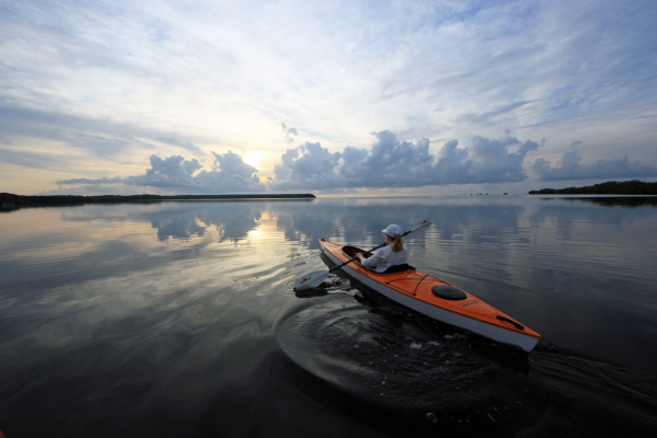 A woman kayaks through Biscayne Bay National Park at sunrise off Black Point; (photo/Shutterstock)