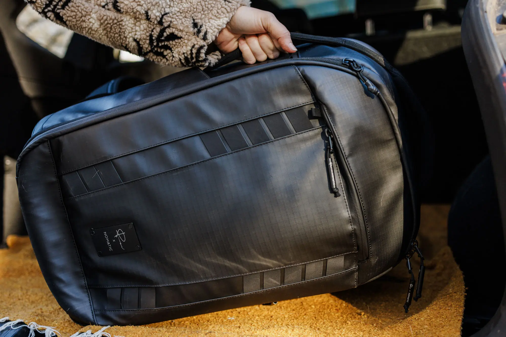 carrying Nomatic McKinnon 35L Camera Backpack