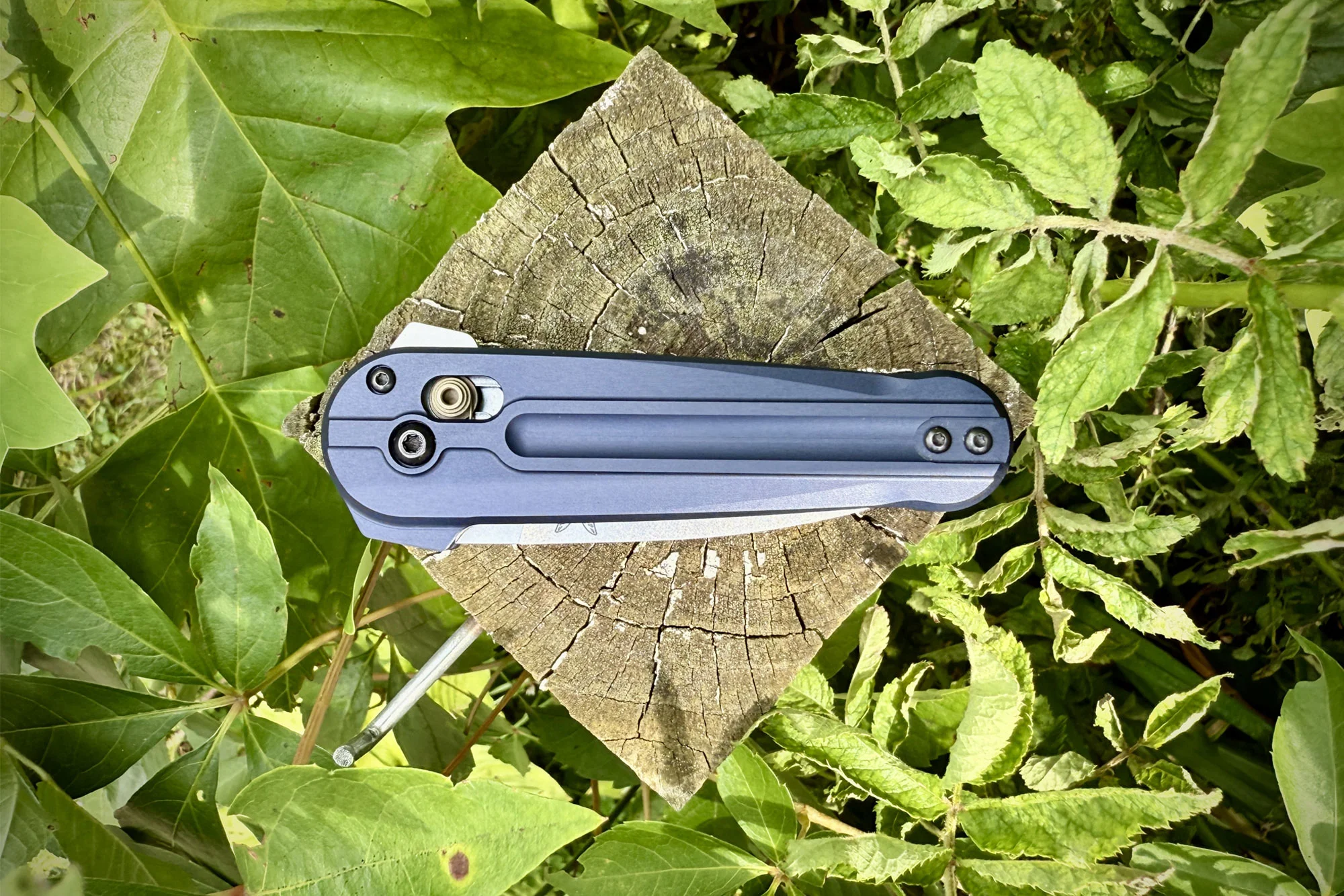 closed Benchmade Lowden knife on a wooden stump