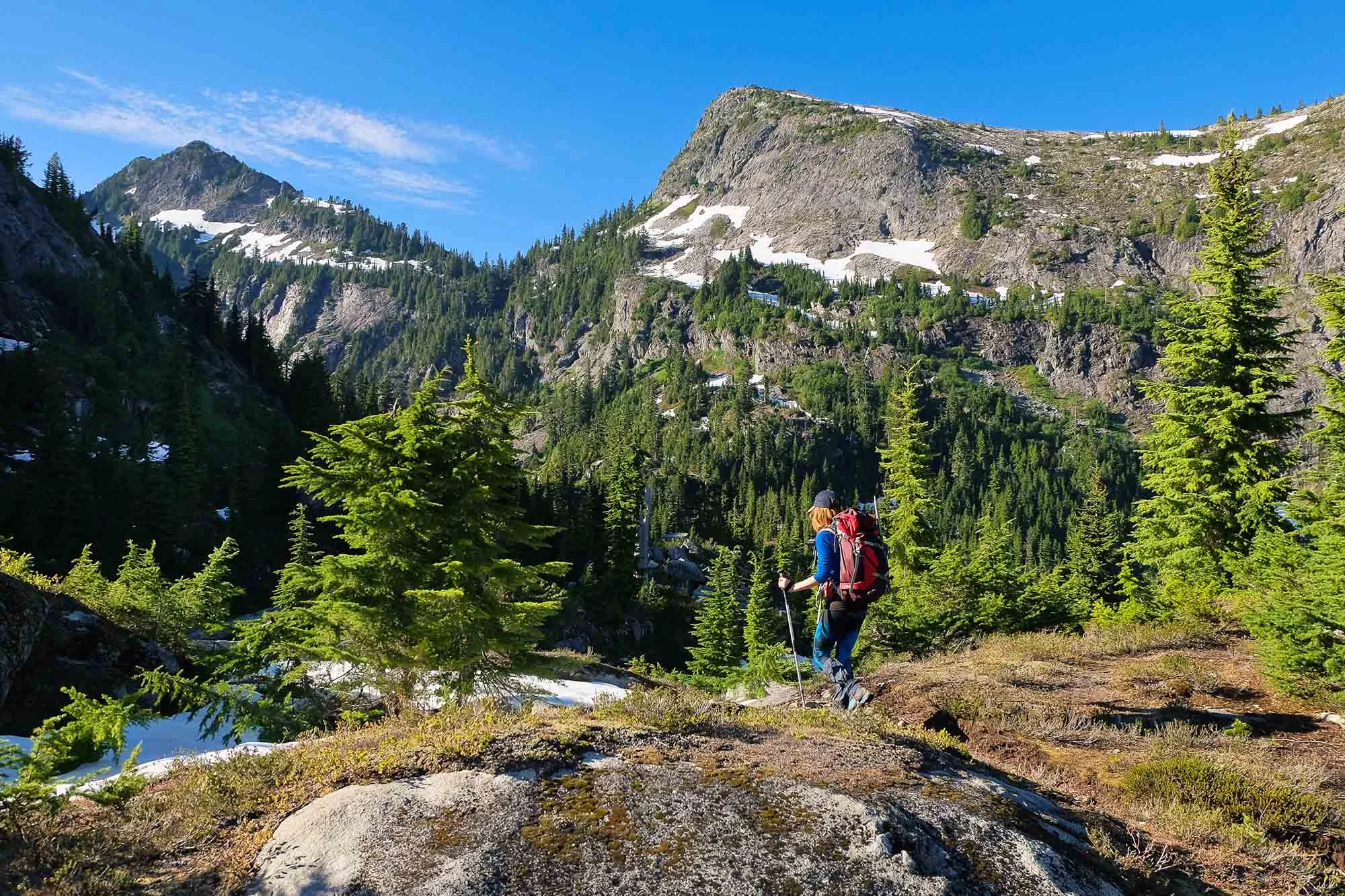 A Woman Hiker Among Stunning Peaks and Forest.