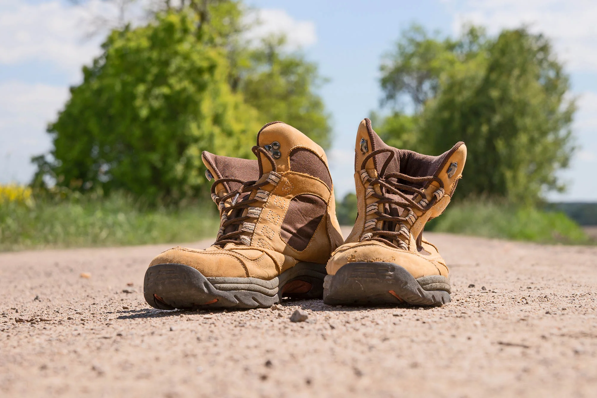 Hiking boots on a dusty dirt road