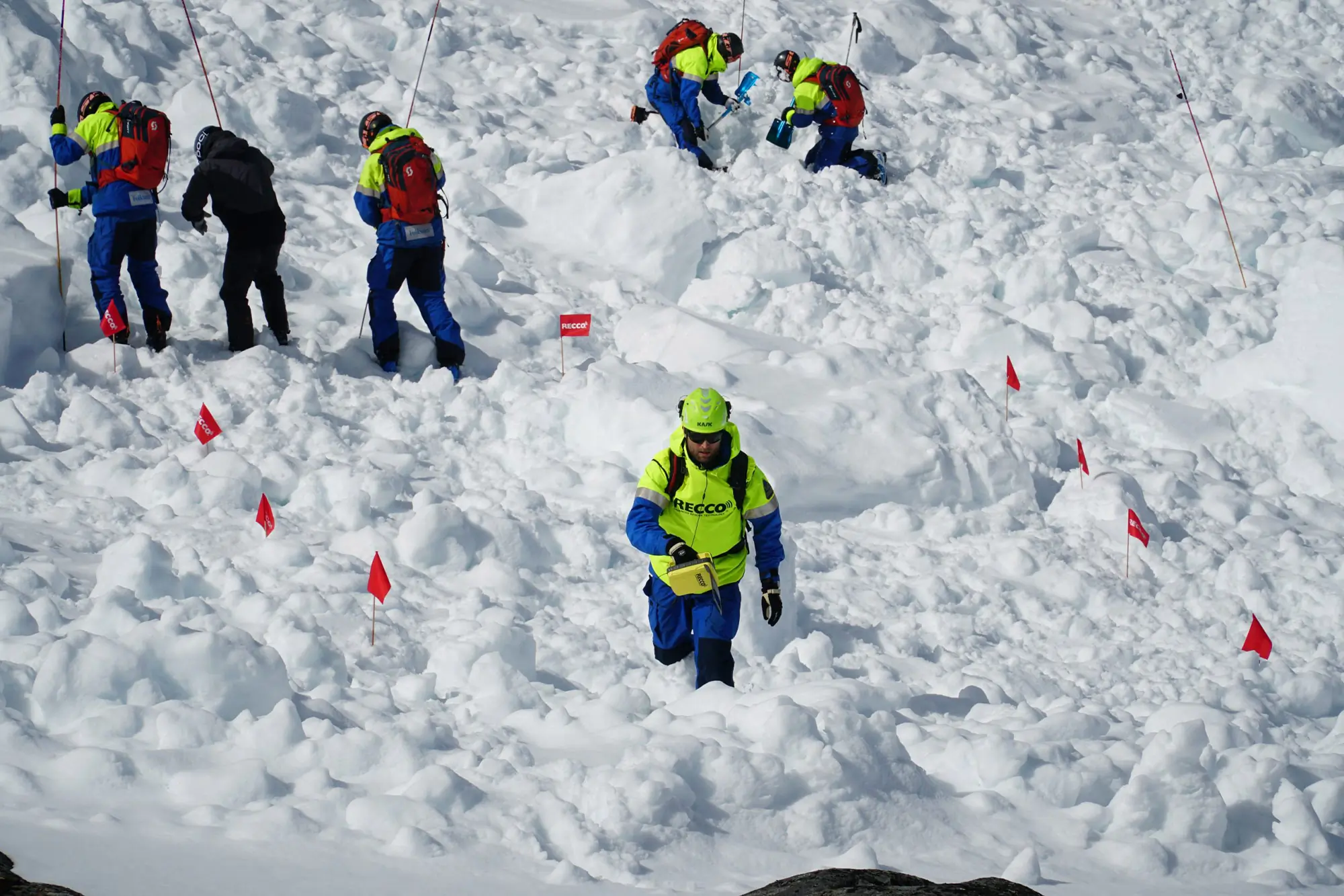RECCO rescue team searches avalanche debris with handheld detectors