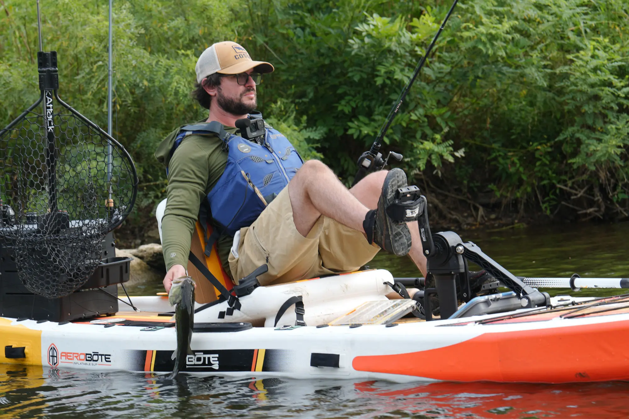 a man in a kayak with the Shimano Caius casting combo