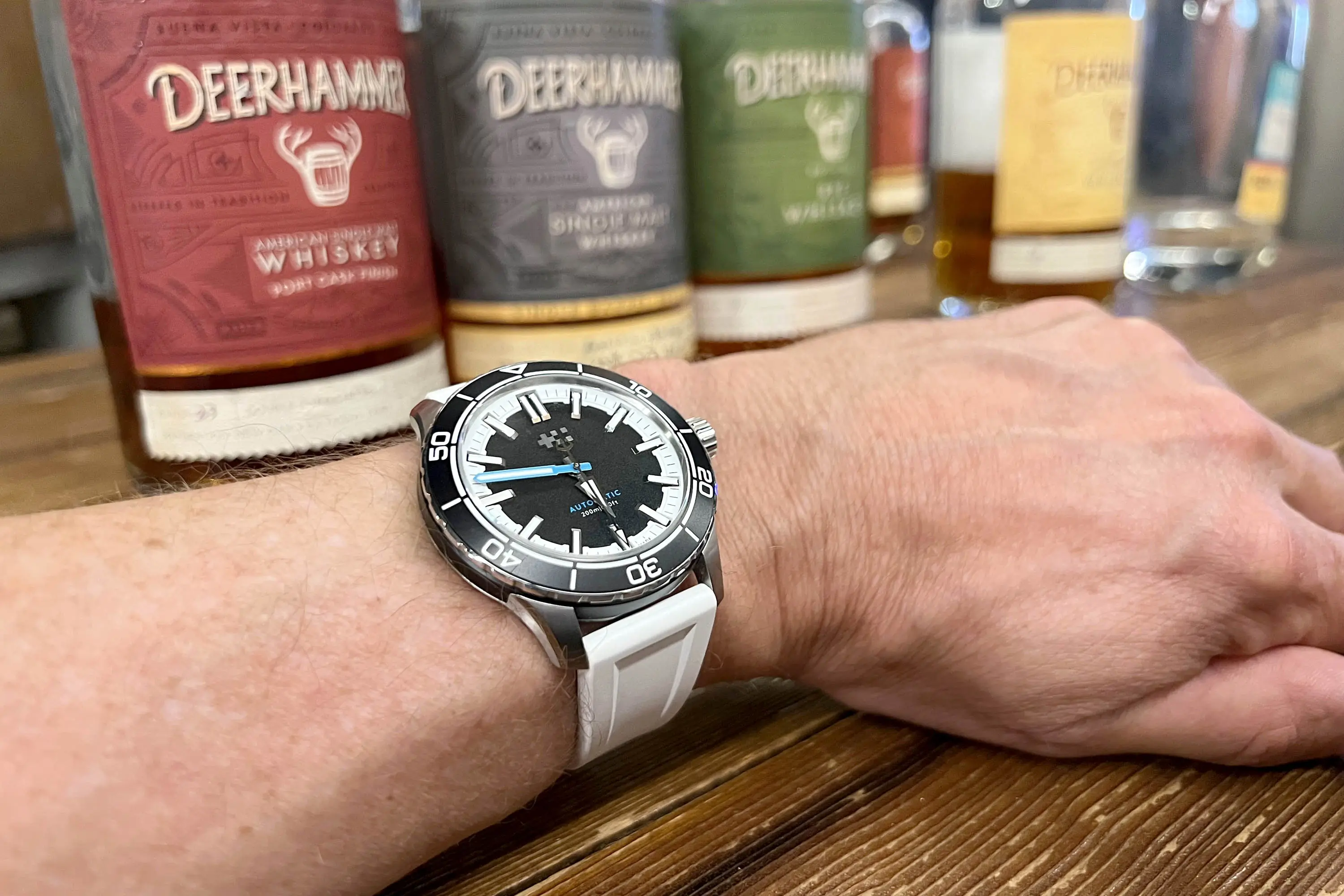 Christopher Ward Trident Reef with whiskey bottles