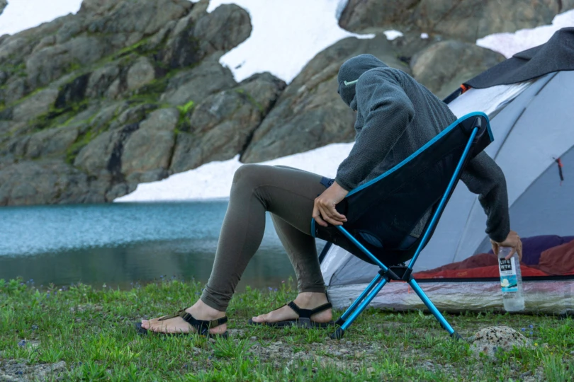 the author sits in the chair one (re) beside an alpine lake in washington state