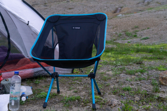the helinox chair one (re) sits beside a tent at a camp in washington state