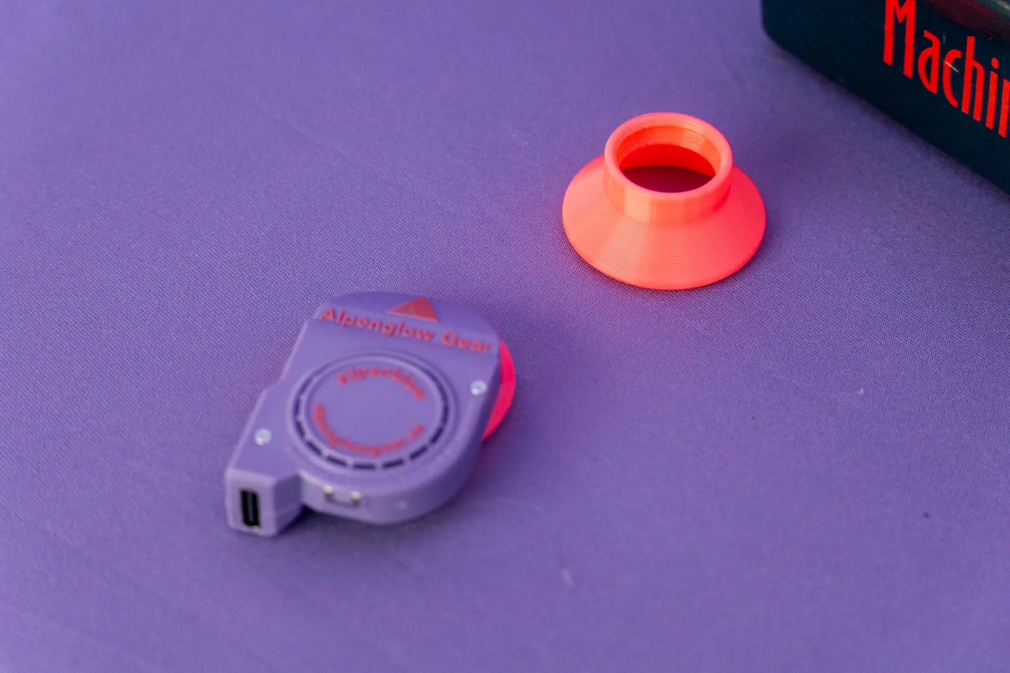 the alpenglow gear alpenblow inflator sits on a purple background