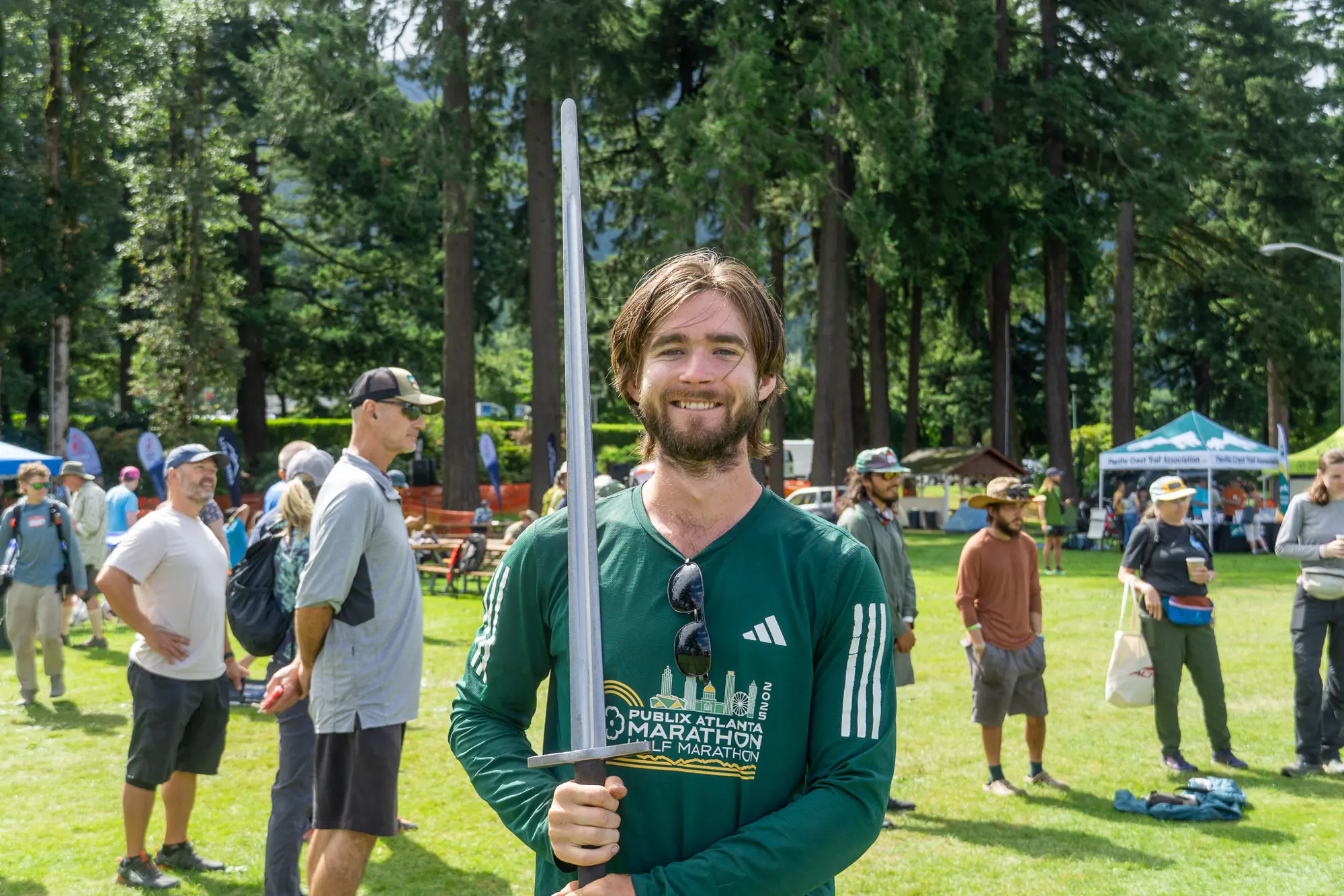 pct hiker nevermore poses with his sword at pct days 2025