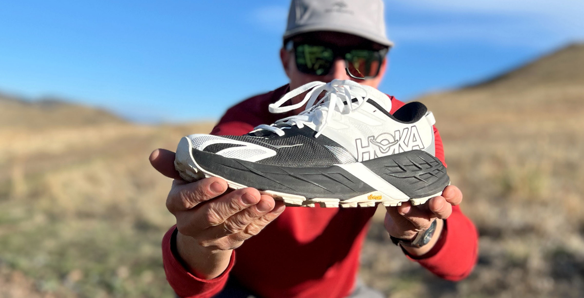 Man holding HOKA Speedgoat 7