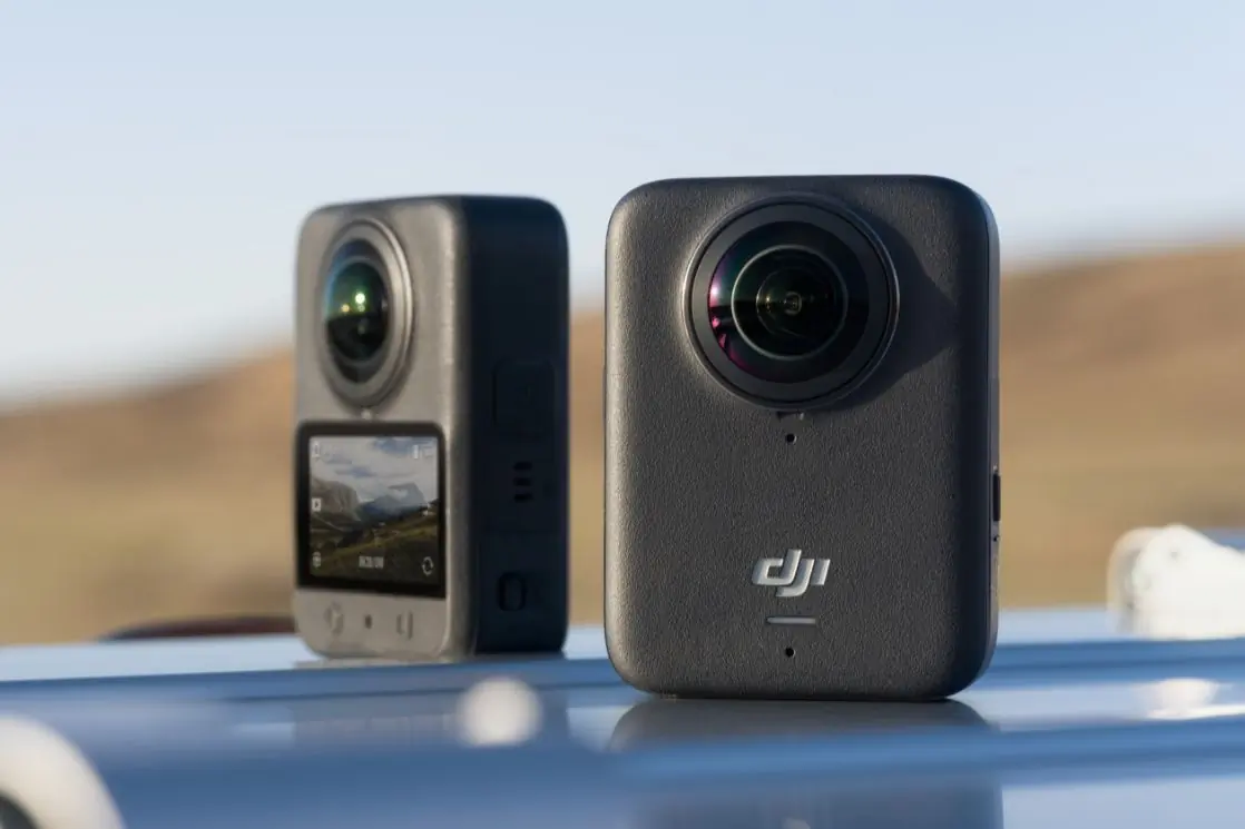 Two black adventure cameras side by side, one showing front, one showing back.