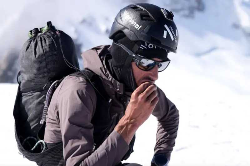 Close Up of man in all black on snowy environment