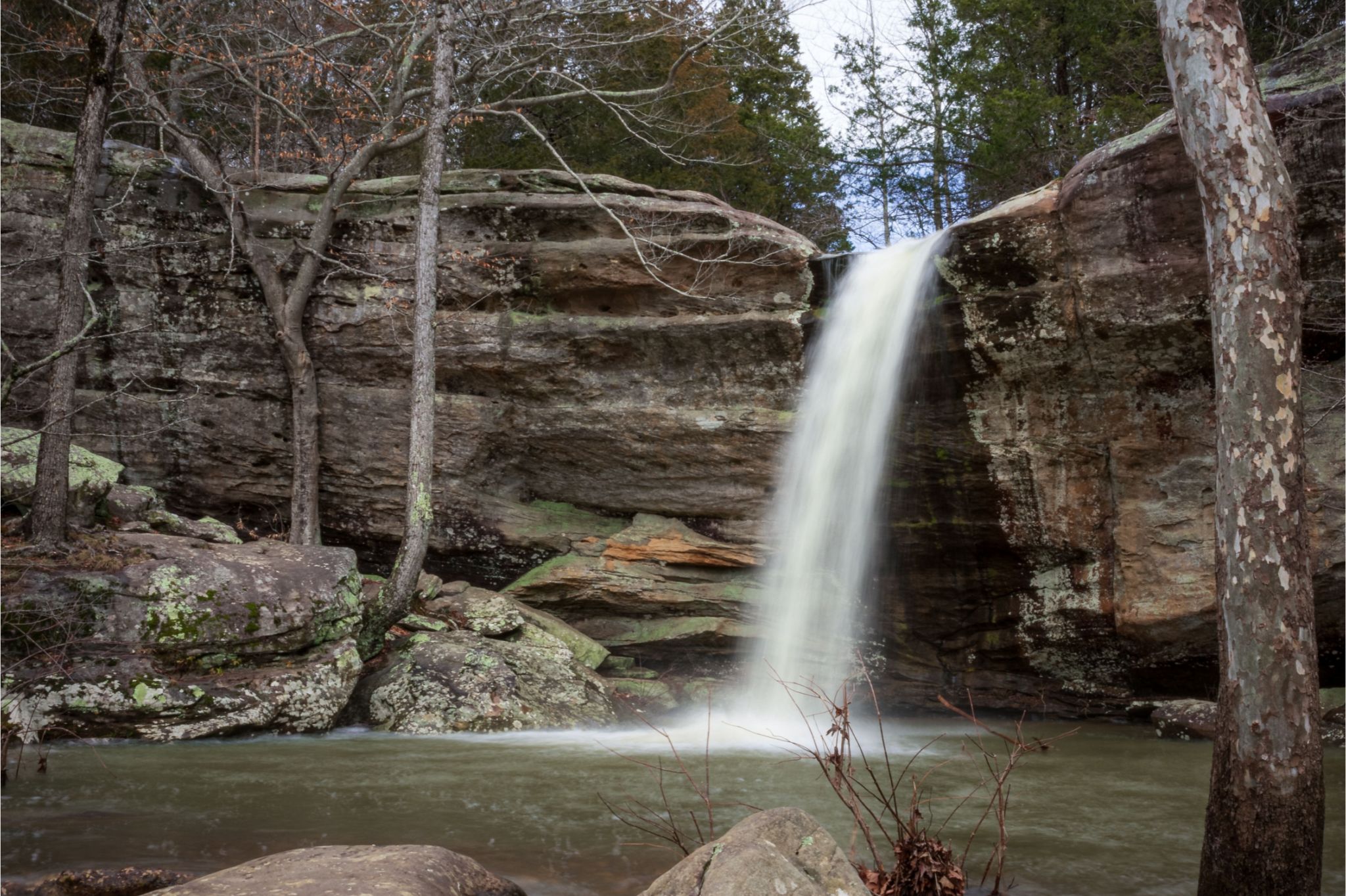 Water fall goes into pool. 