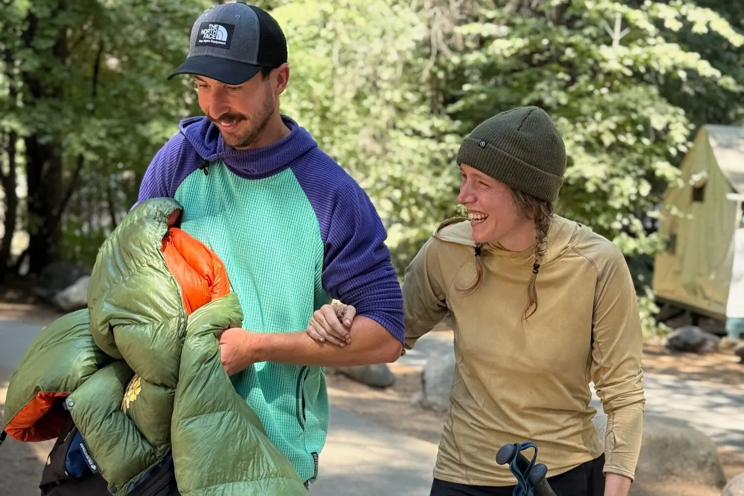 Man and woman link arms walking outside