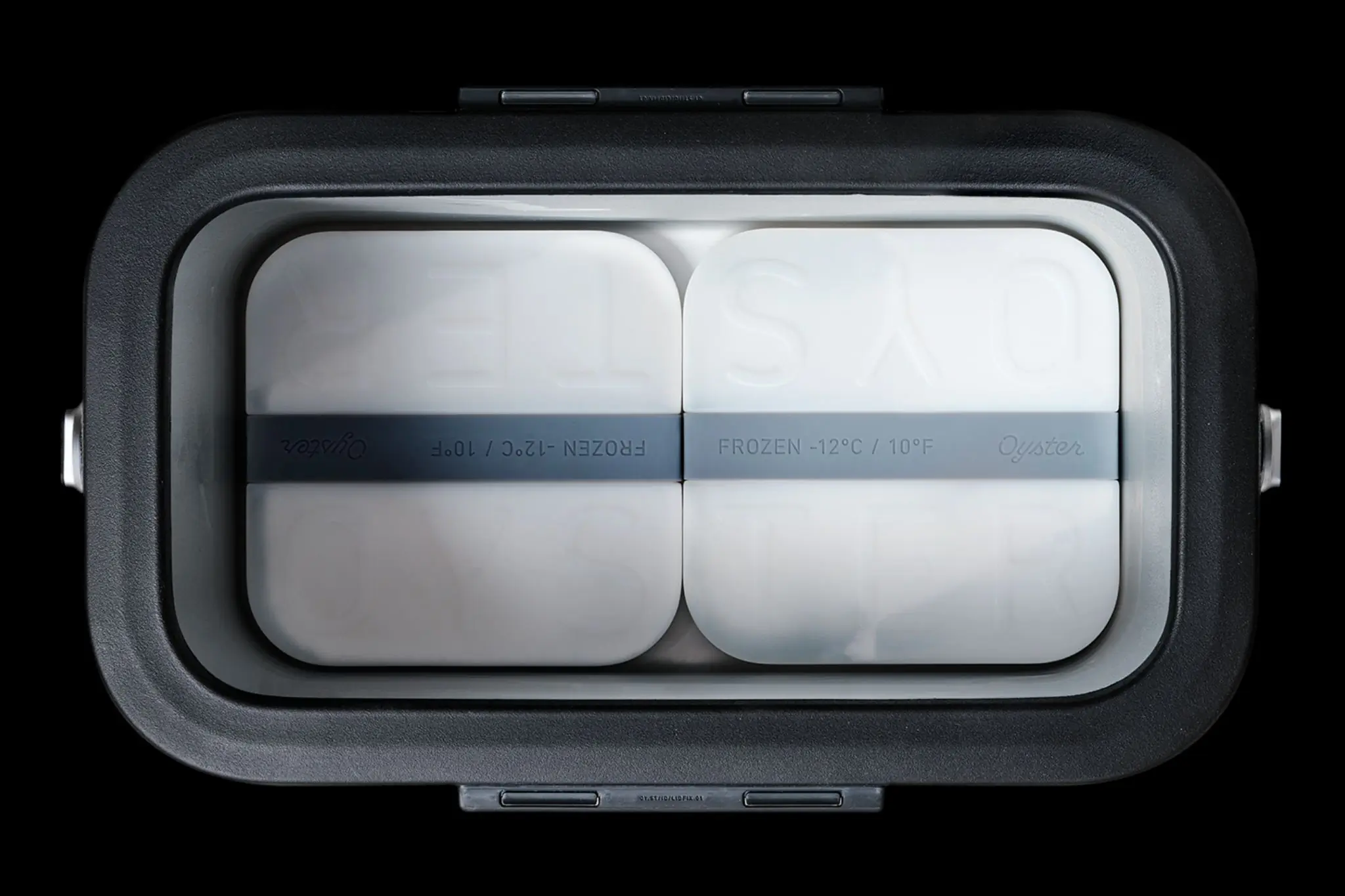 Oyster white ice packs inside a cooler against a black background. 