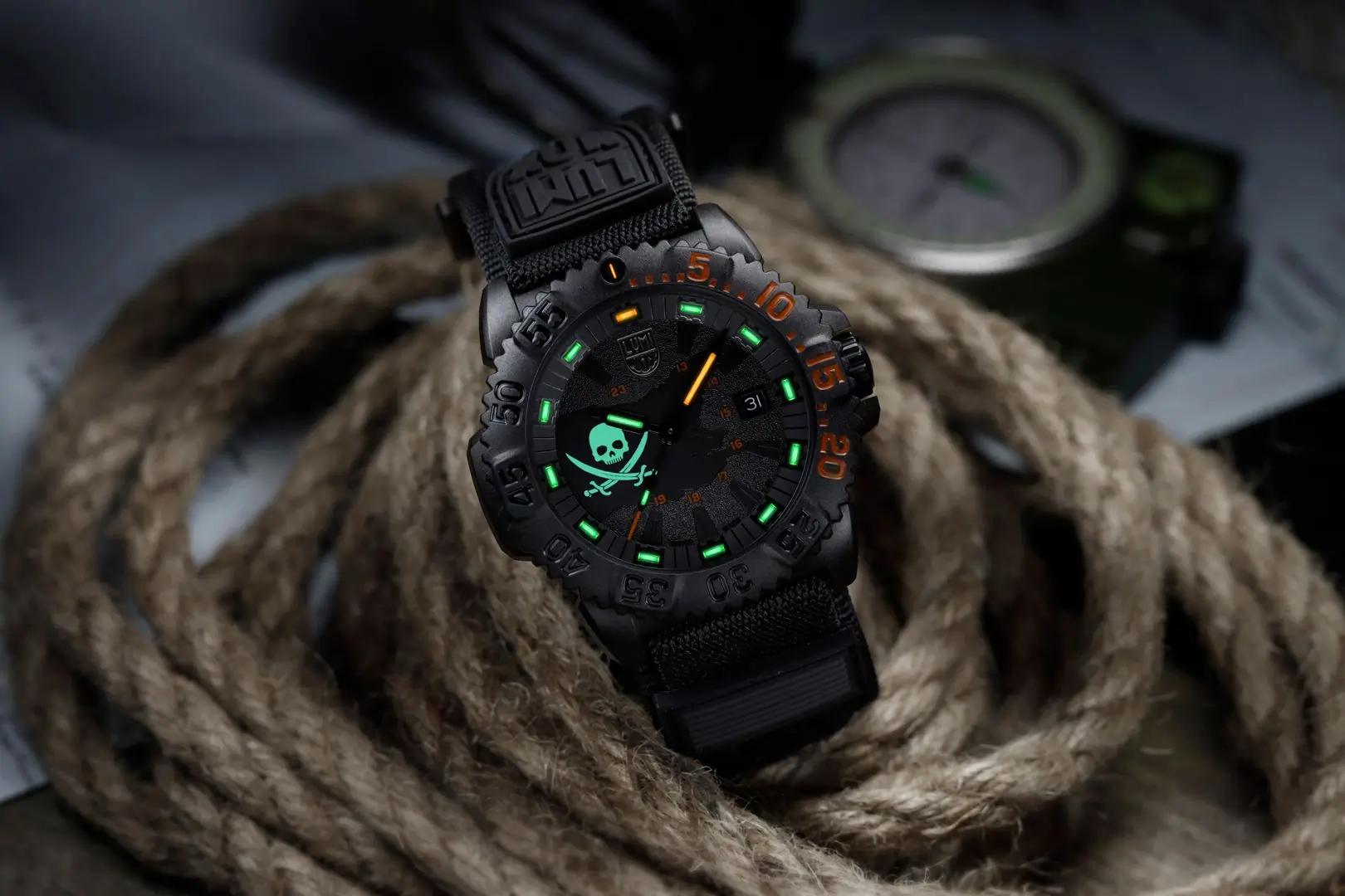 Glowing black watch on pile of rope