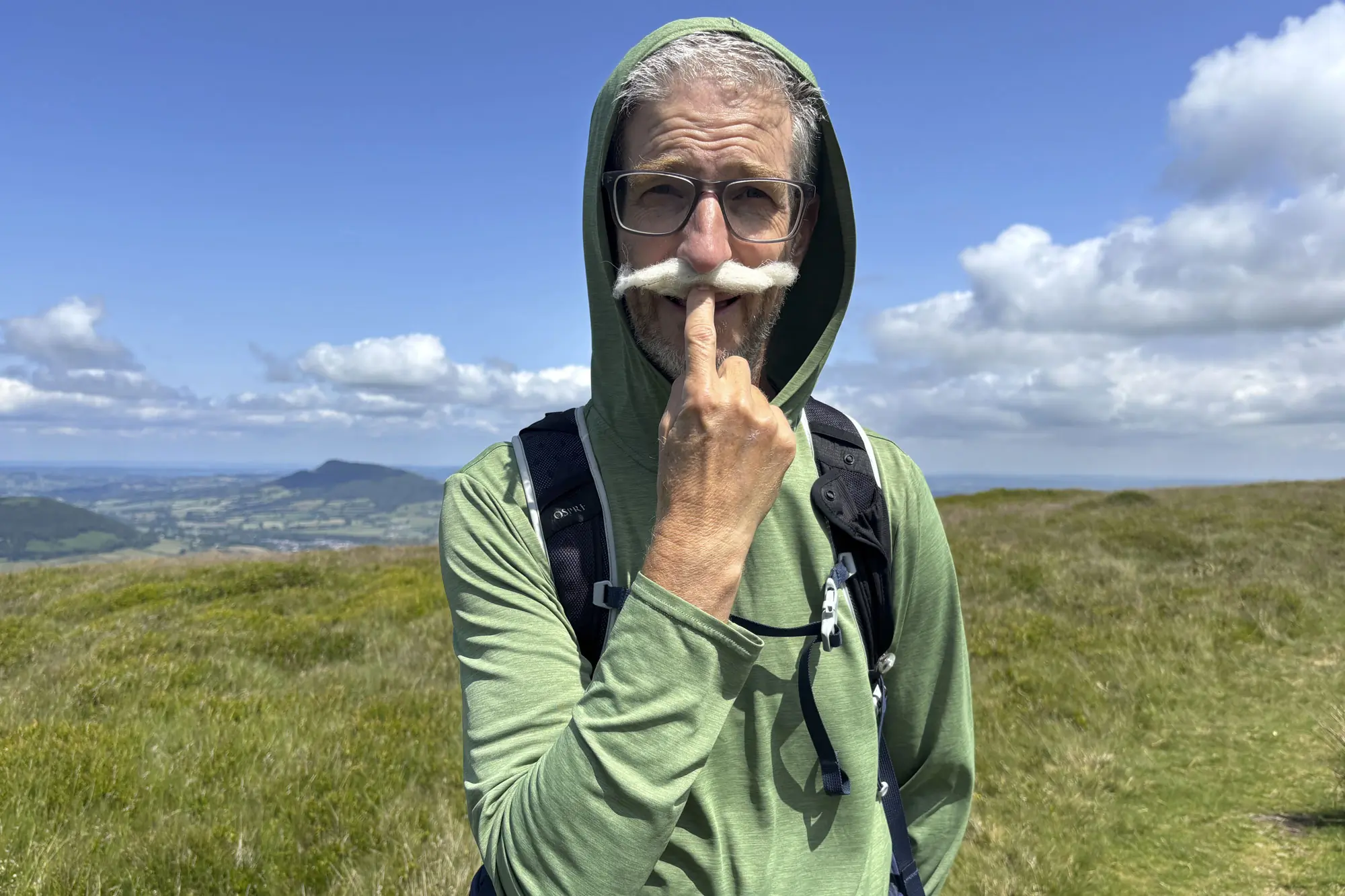 a man wearing Patagonia Capilene Cool Daily Hoody on a mountain