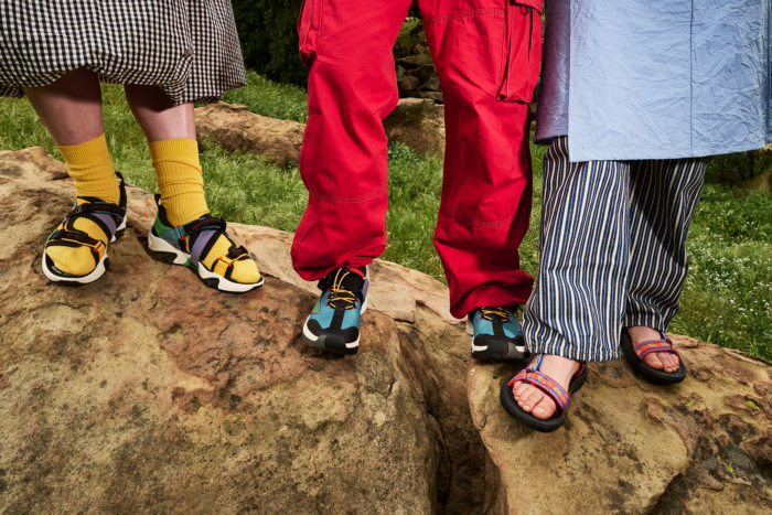 Close up of three people wearing sandals and shoes in loud colors.