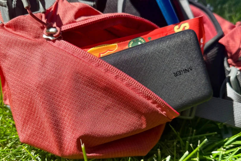 Anker 313 Power Bank stored in a red backpack pocket