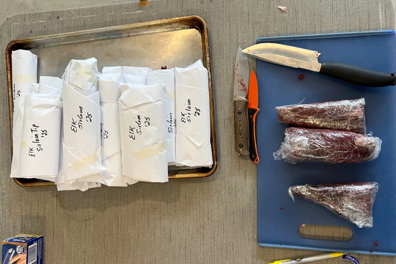 A few cuts of meat, knives, and cutting board