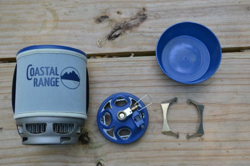 Parts of a stove laid out on picnic table