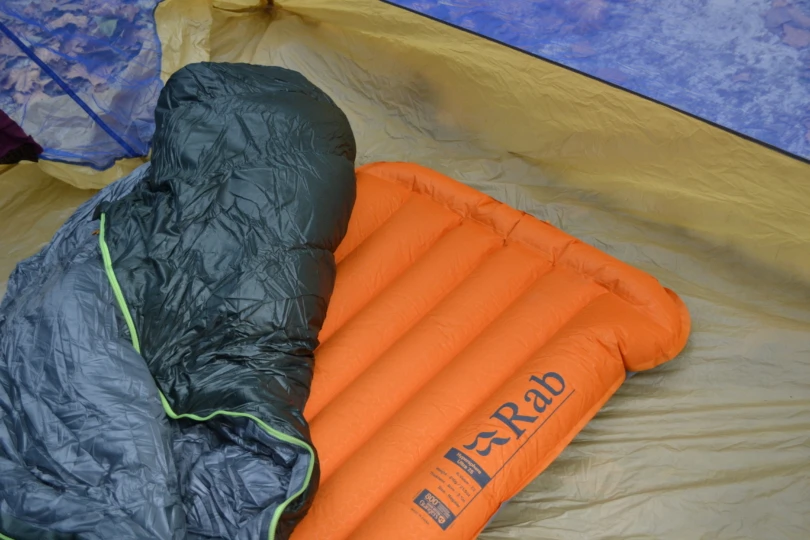 Close up of sleeping pad on tent floor with sleeping bag on top
