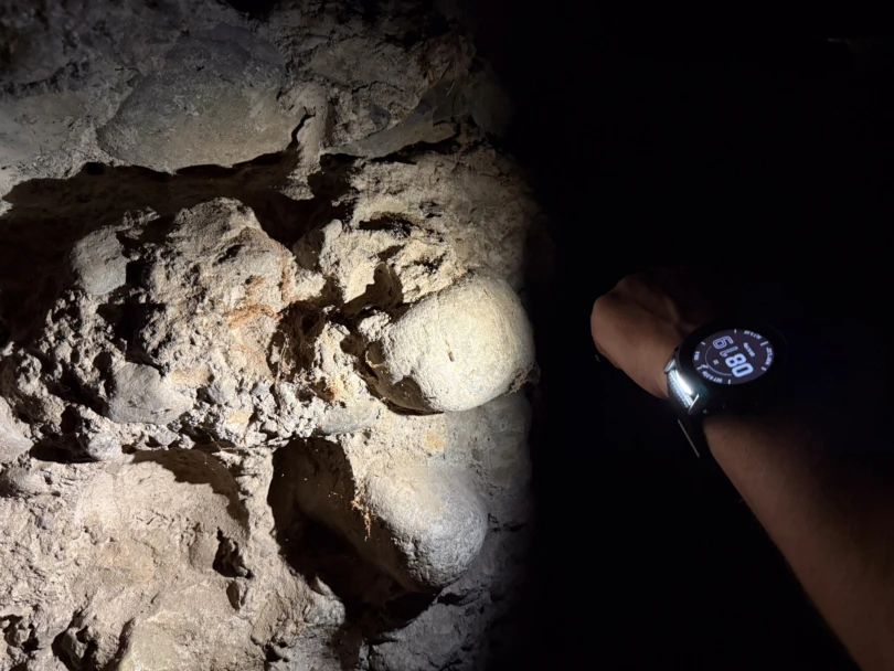 the author uses the LED flashlight on the enduro 3 watch to illuminate a rock face