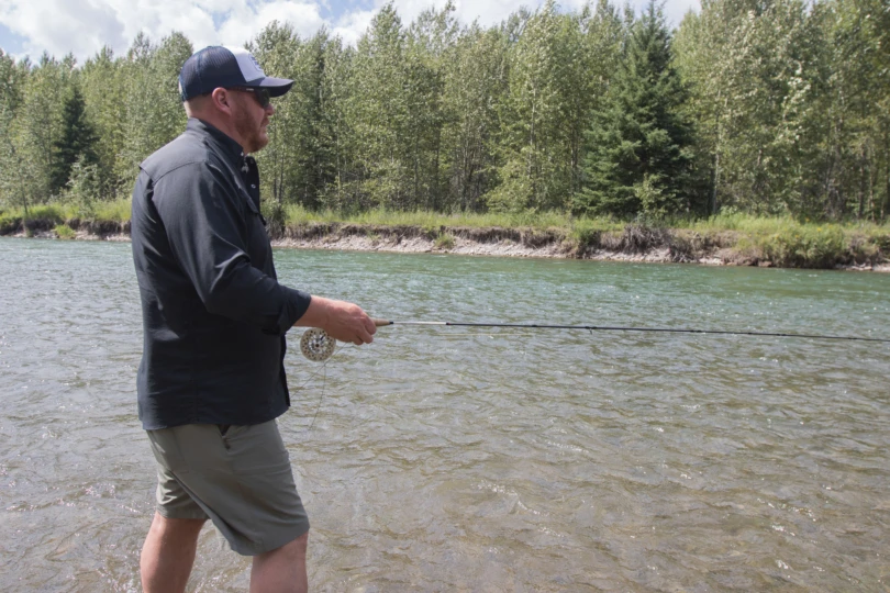 An angler fishing with the Orvis Superfine Graphite fly rod/