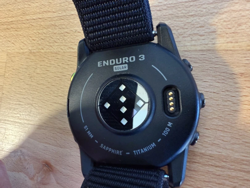 the back of the enduro 3 watch, detailing the heart rate monitor and charging port