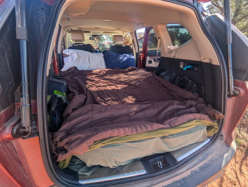 bedding atop the luno mattress in the back of a honda cr-v