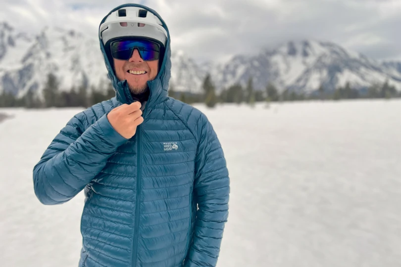 Mountain Hardwear Ghost Whisperer Hoody in blue zipped up in the snow