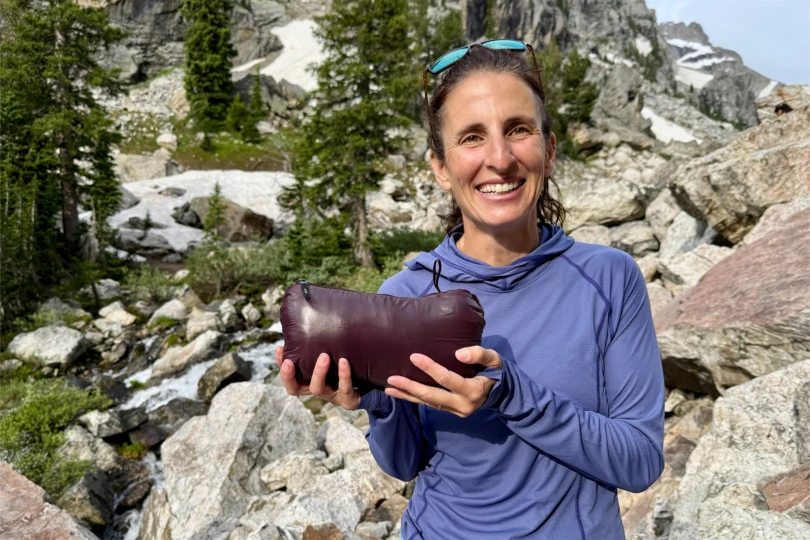 Mountain Hardwear Ghost Whisperer Hoody packed in its stuff sack held in hands