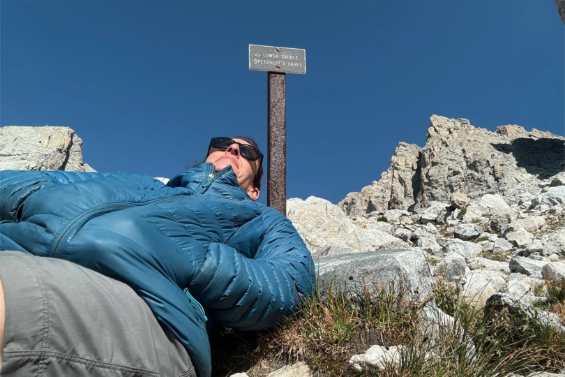 Patagonia Down Sweater Hoody while resting on a rocky slope