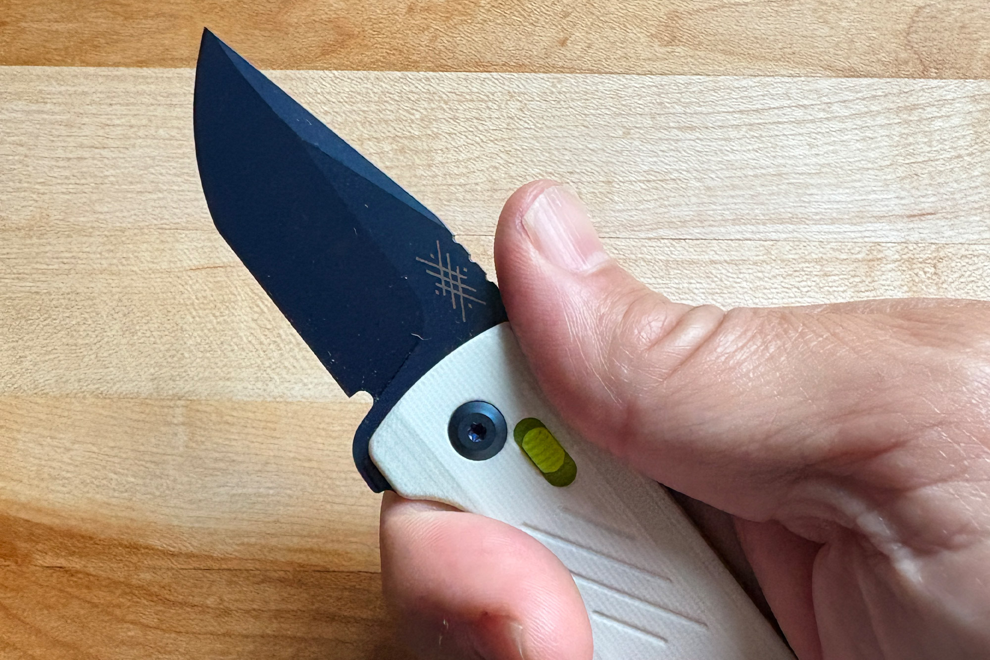 A hand holding the open Pepperwool Merino MM