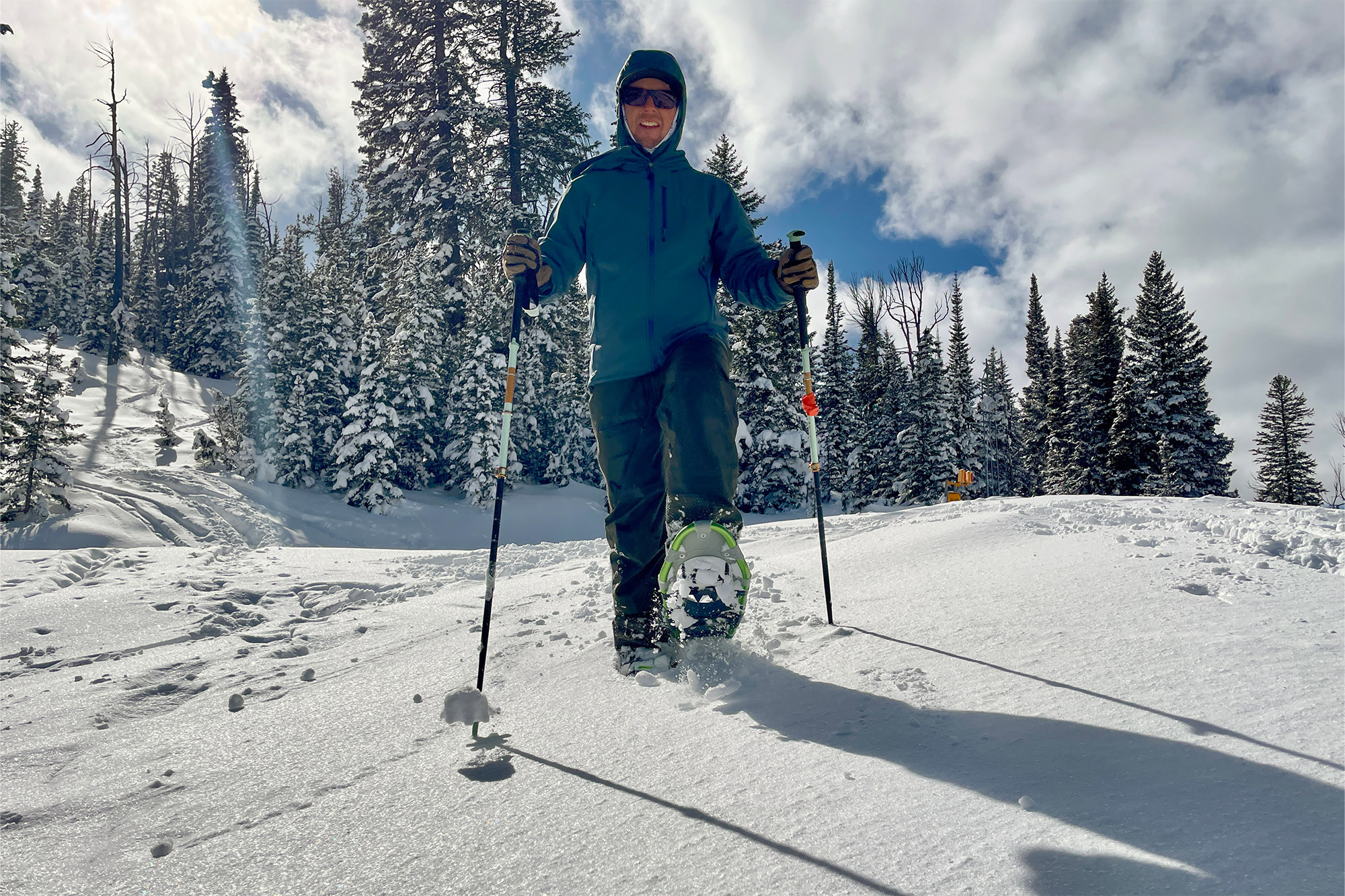 Tubbs Mountaineer in use on a snowy trail with poles