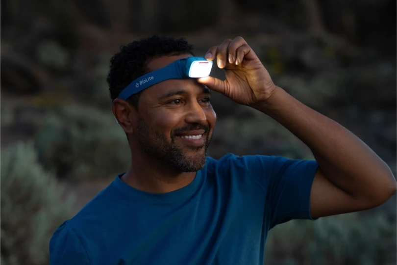 Persons adjusts blue headlamp that is turned on