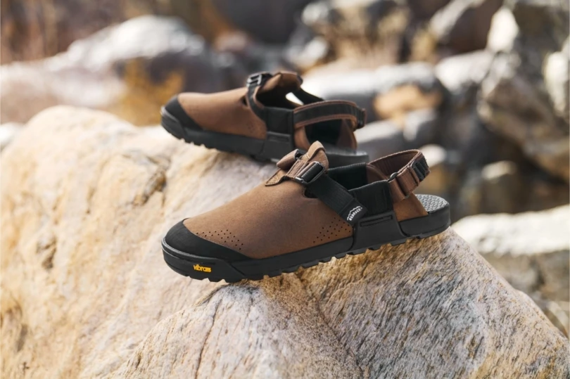 Brown leather clogs on rocks