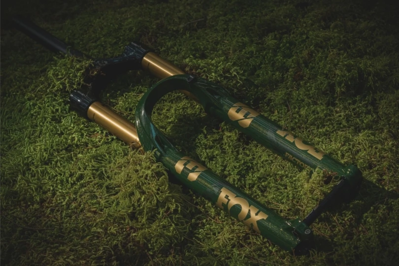 Gold and green biking fork on grass 