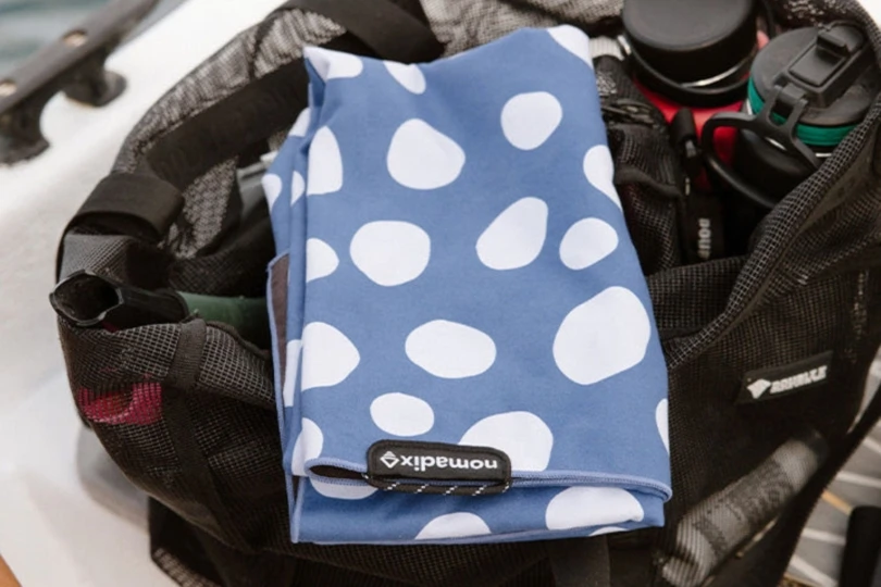 Polka dot towel folded up on toiletry bag