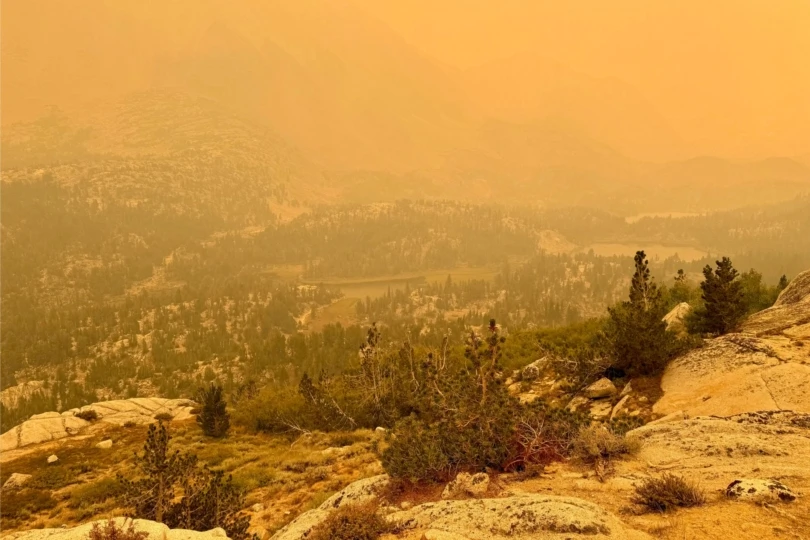 mountain landscape in orange, smoky haze due to wildfires
