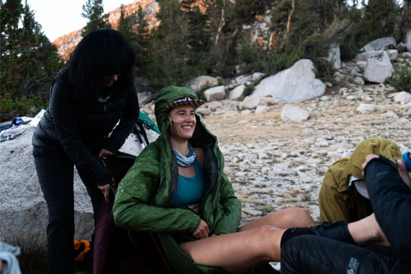 Woman sits in chair in mountains